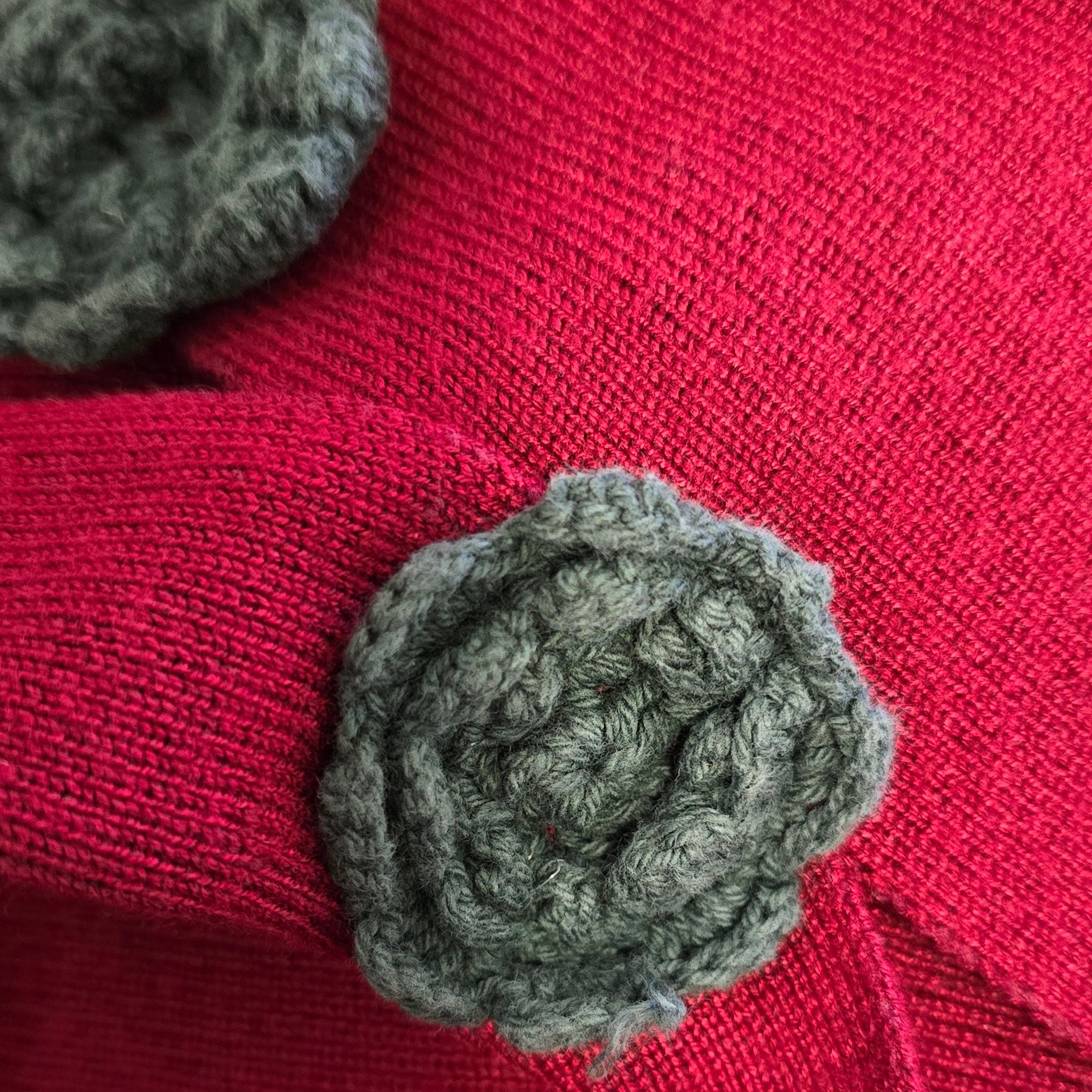 Red fabric with gray textured buttons