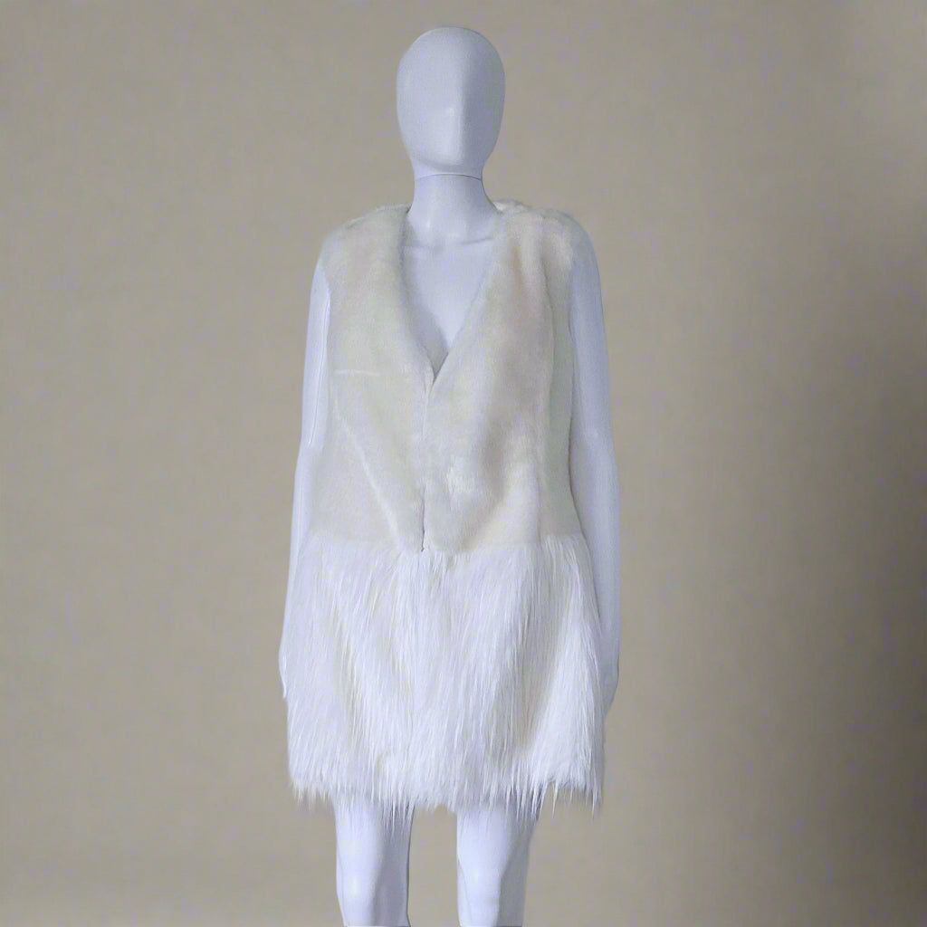 Mannequin wearing a white fur vest against a plain background