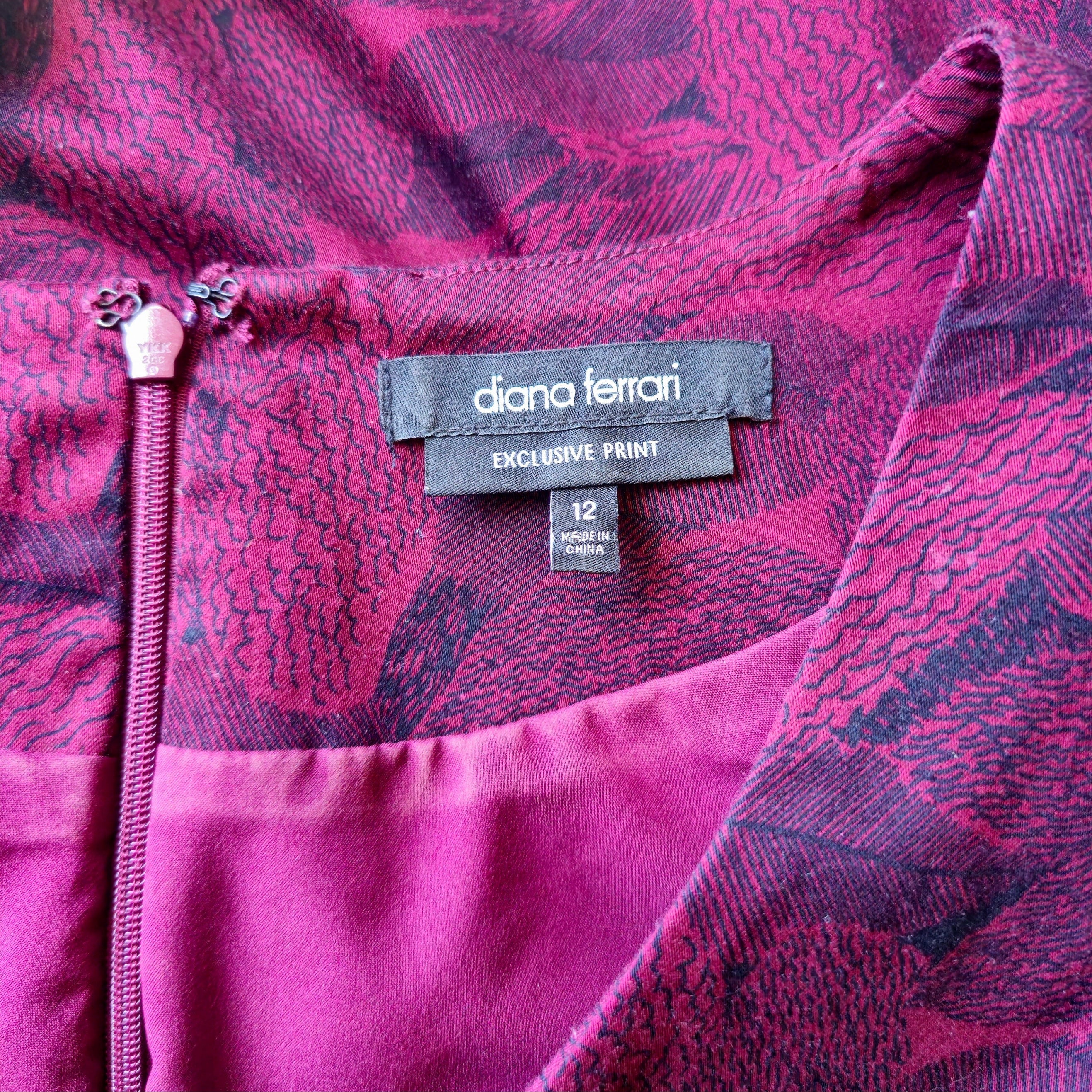 Close-up of a pink garment with 'diana ferrari' label and size tag.