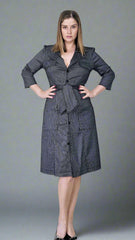 Woman wearing a gray dress against a gray background