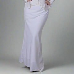 A white linen maxi skirt with a high waist and back split, displayed on a model against a plain background.