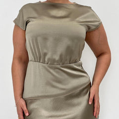 A model wearing an olive-colored, fitted knee-length dress with short, cap sleeves and a keyhole back neckline.