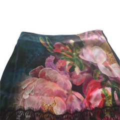 Floral patterned fabric with pink and green colors on a plain background