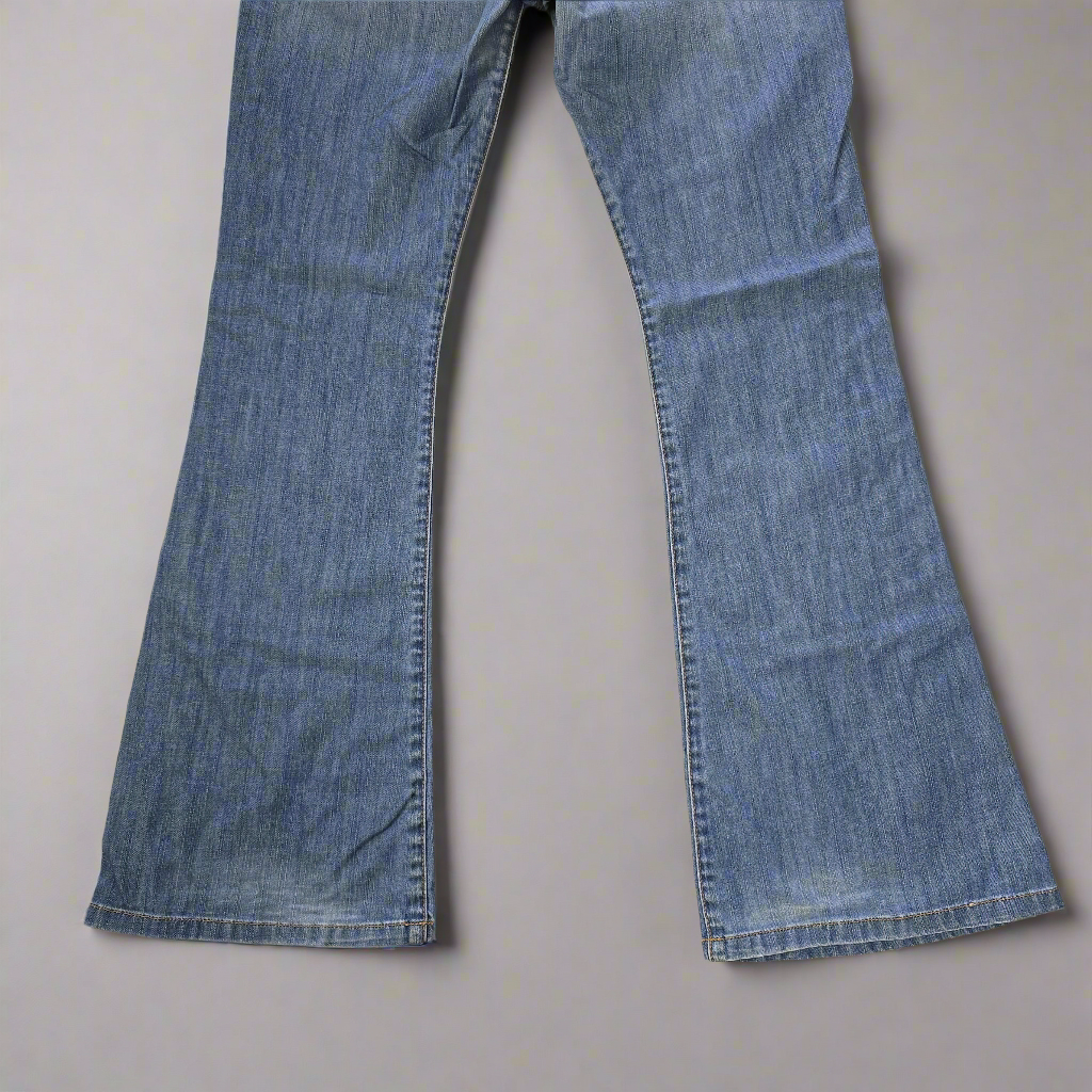 Pair of blue jeans on a beige background