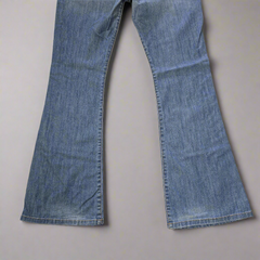 Pair of blue jeans on a beige background