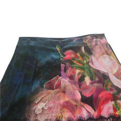Floral patterned fabric with pink and green colors on a plain background