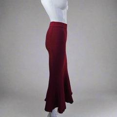 Red skirt on a mannequin against a plain background