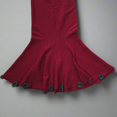 Red dress with decorative buttons on a plain background