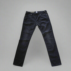 Dark grey jeans on a gray background