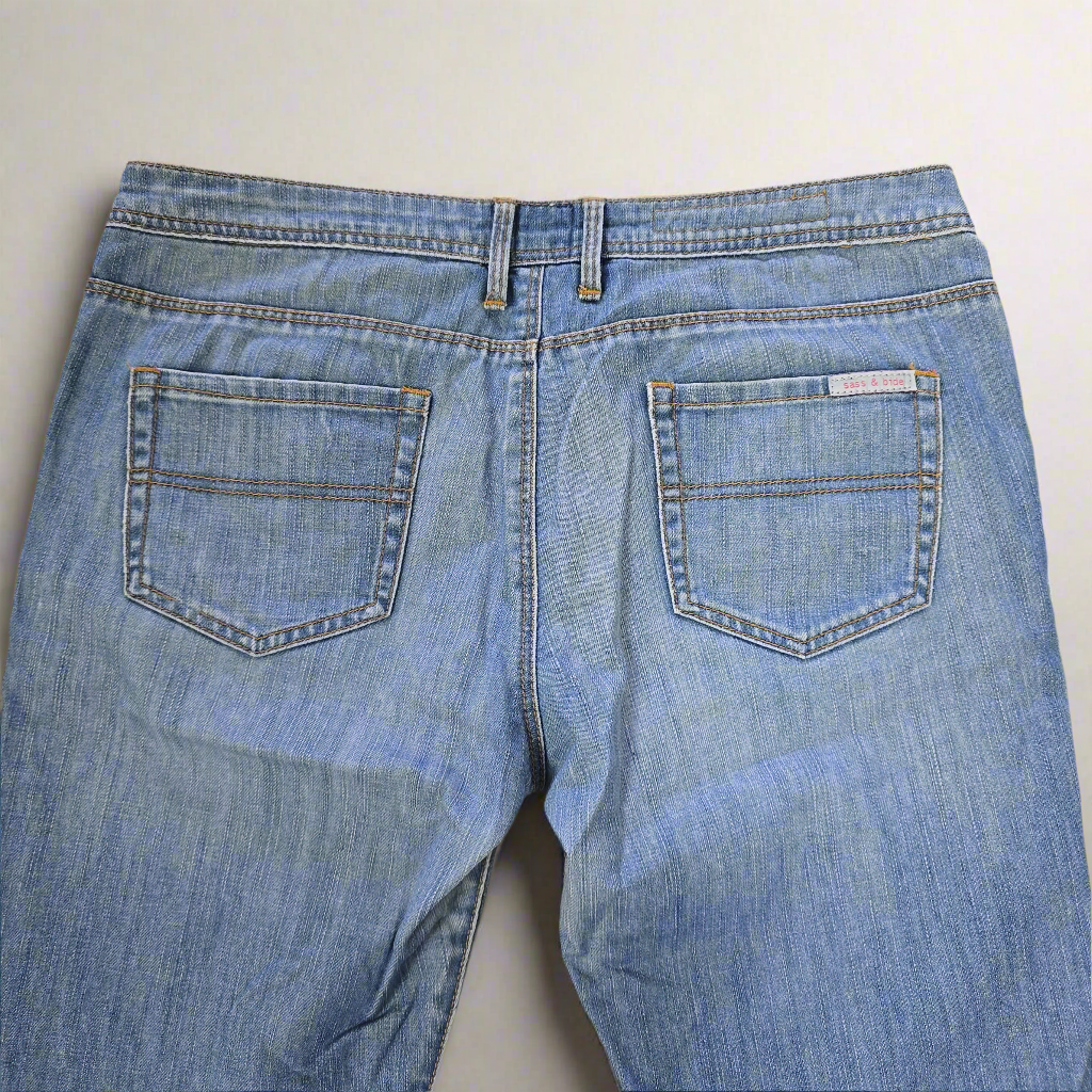 Back view of a pair of blue jeans on a light background