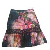 A floral skirt with a variety of colors, predominantly pink and green, with a lace trim at the waist.