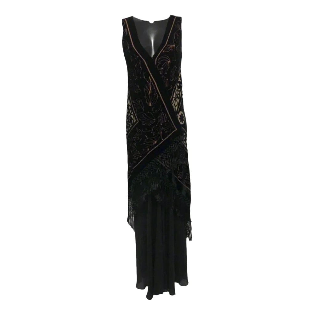 Black evening gown with intricate detailing on a gray background