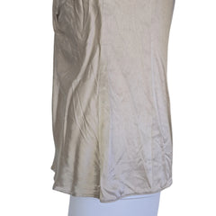 Beige top with a knot detail on alight floor