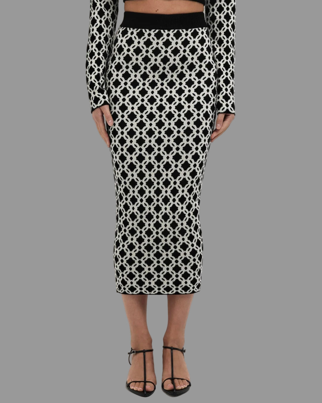 Black and white patterned skirt worn by a person on a white background