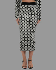 Black and white patterned skirt worn by a person on a white background