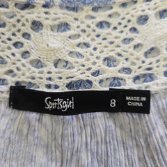 Textile with a 'Sportsgirl' label on a textured fabric background