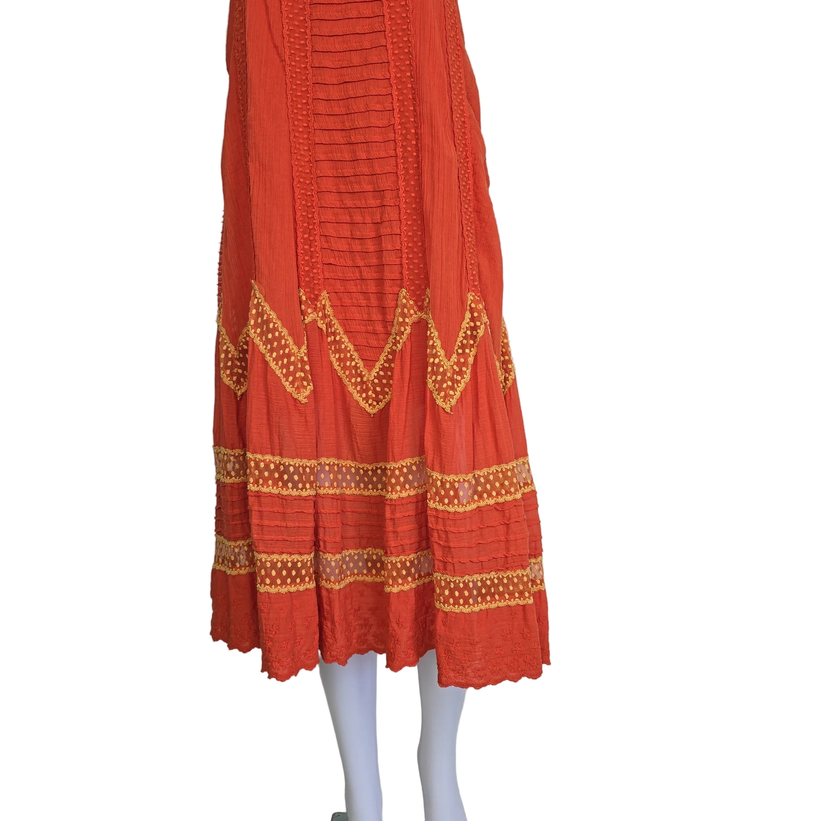 Orange dress with yellow embroidery on a light background