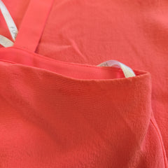Close-up of a pink fabric with a tag.