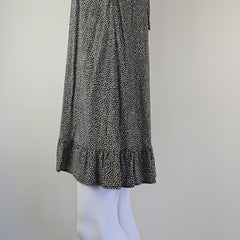 Black and white patterned fabric on a mannequin against a plain background