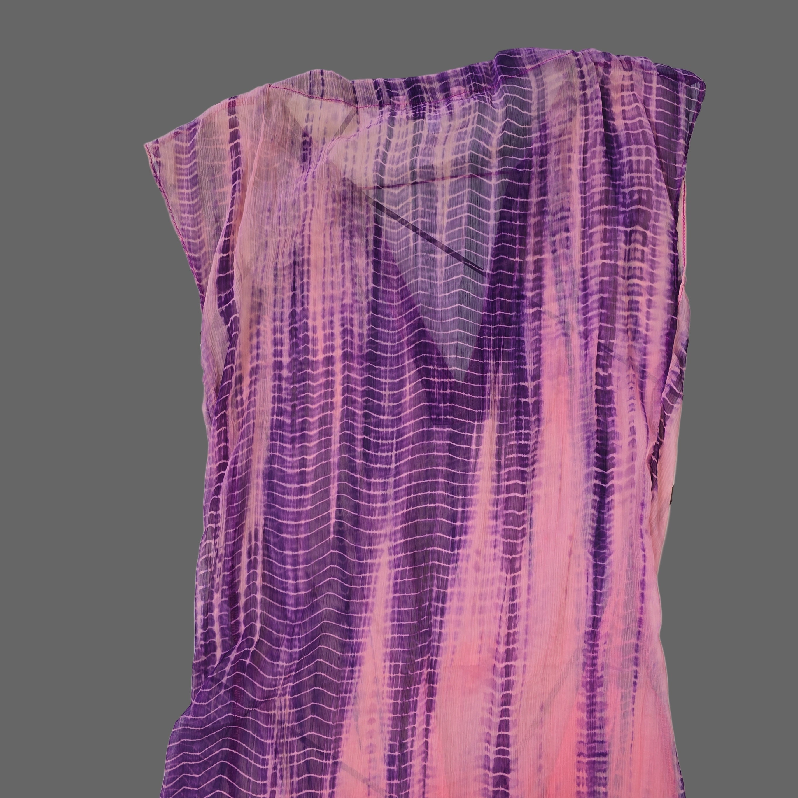 Purple and pink patterned fabric on a tiled floor