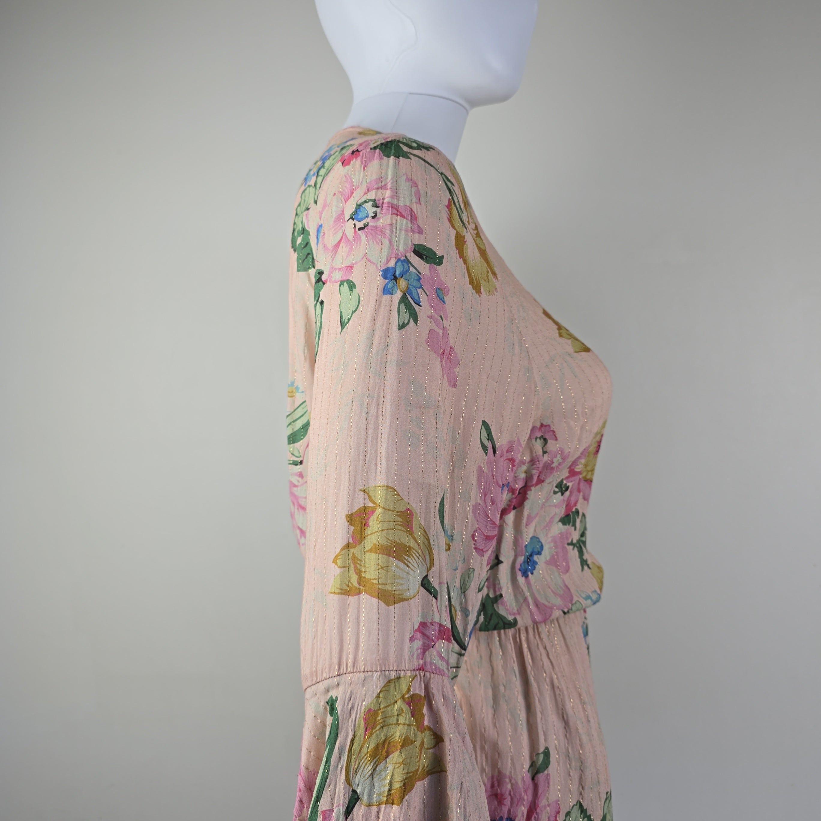 Floral dress on a mannequin against a plain background