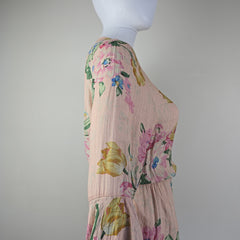 Floral dress on a mannequin against a plain background