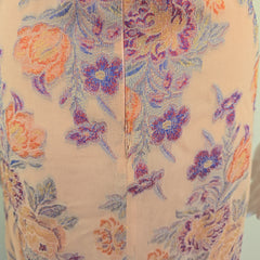 Floral patterned fabric with purple and orange flowers on a beige background