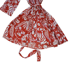 Orange and white palm patterned robe on a light background