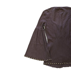 Brown textured fabric with decorative studs on a light background