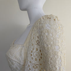 Mannequin wearing a beige lace dress with a neutral background
