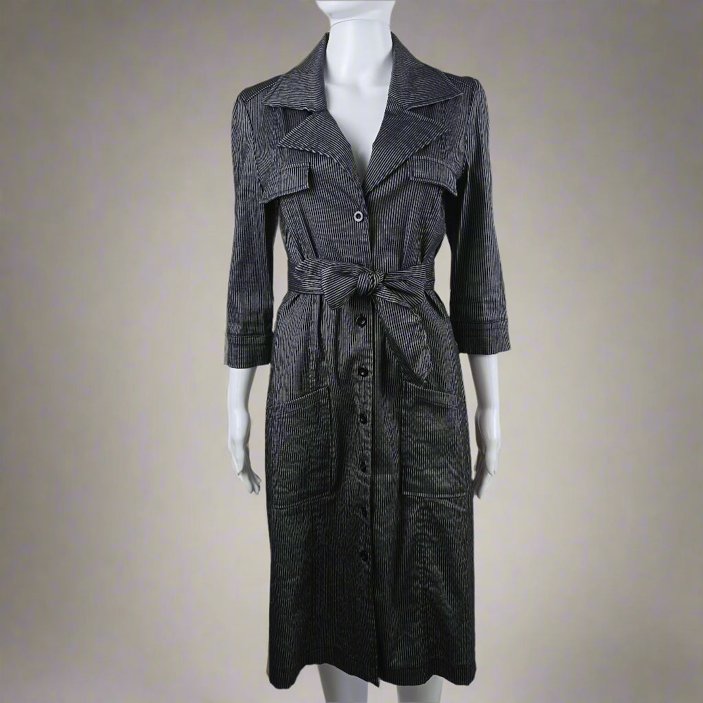 Black coat with a bow tie on a mannequin against a white background