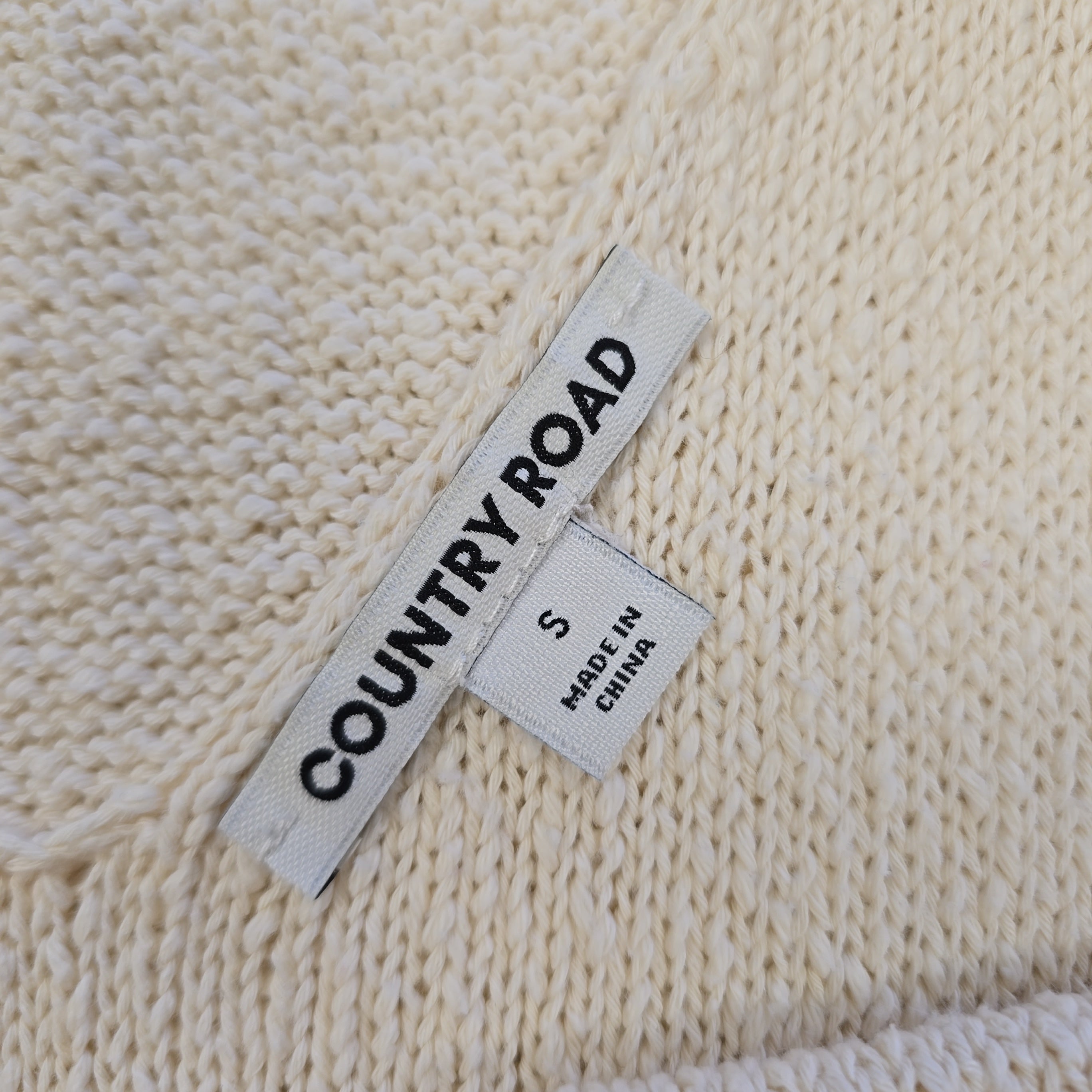 Textile label on a beige knitted fabric