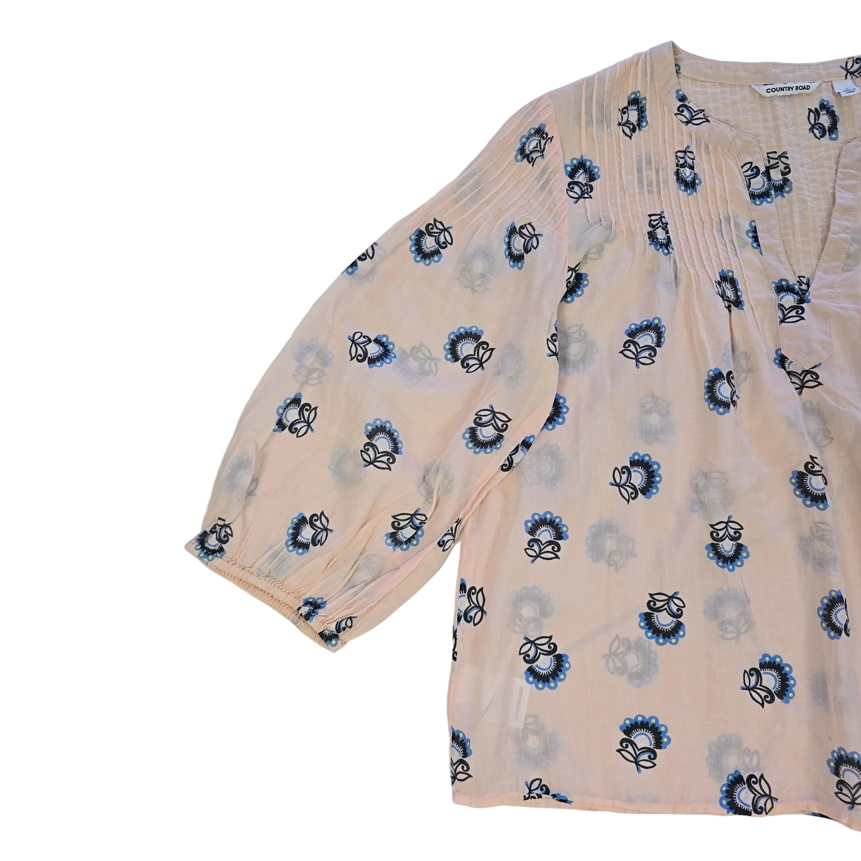 Floral-patterned flowy top on a light background