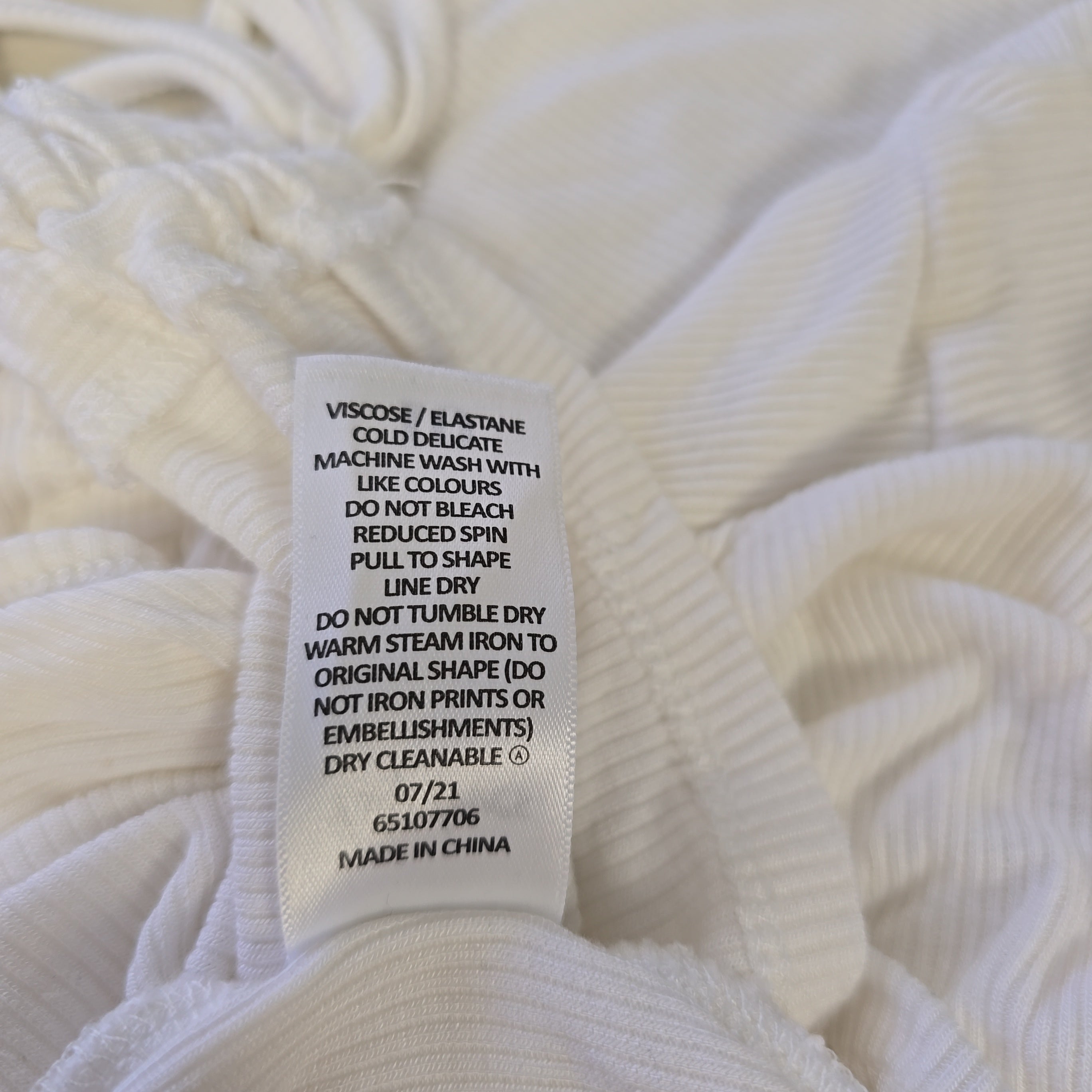 Close-up of a white fabric with a label on it