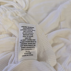Close-up of a white fabric with a label on it