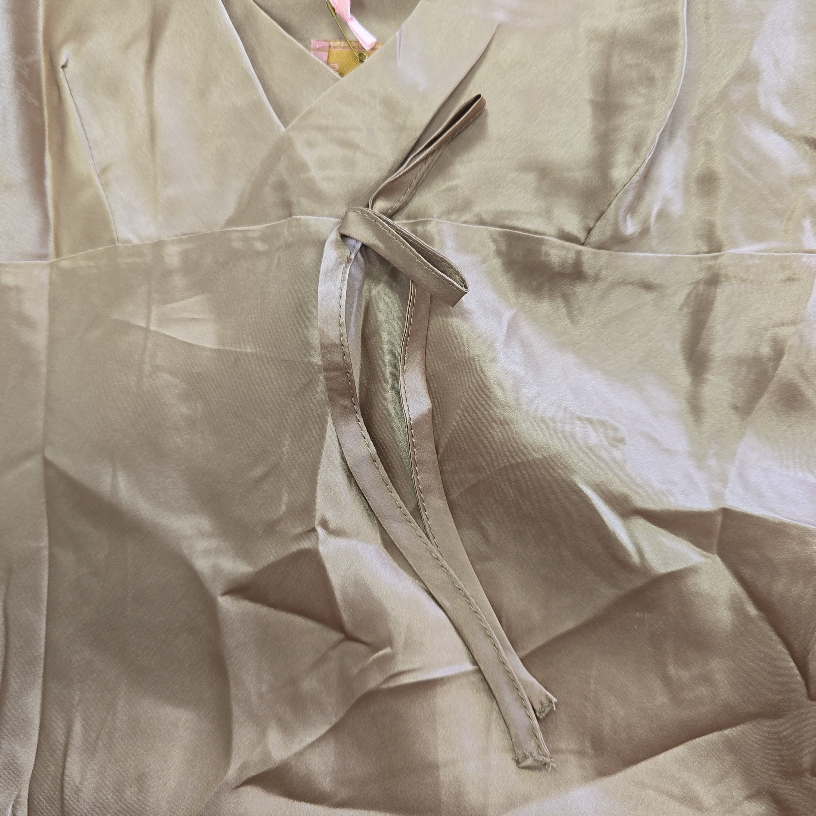 Close-up of a beige silk fabric with a bow