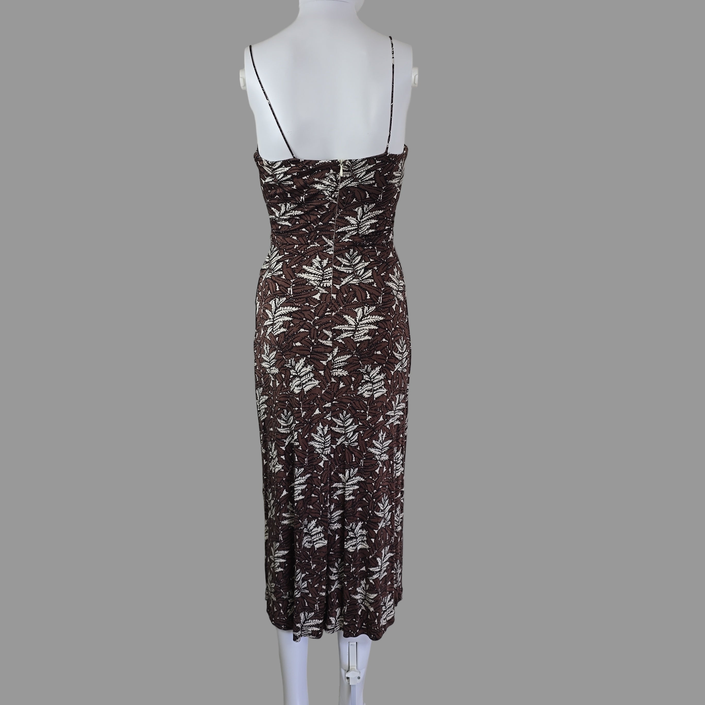 Brown and white patterned dress on a mannequin against a white background