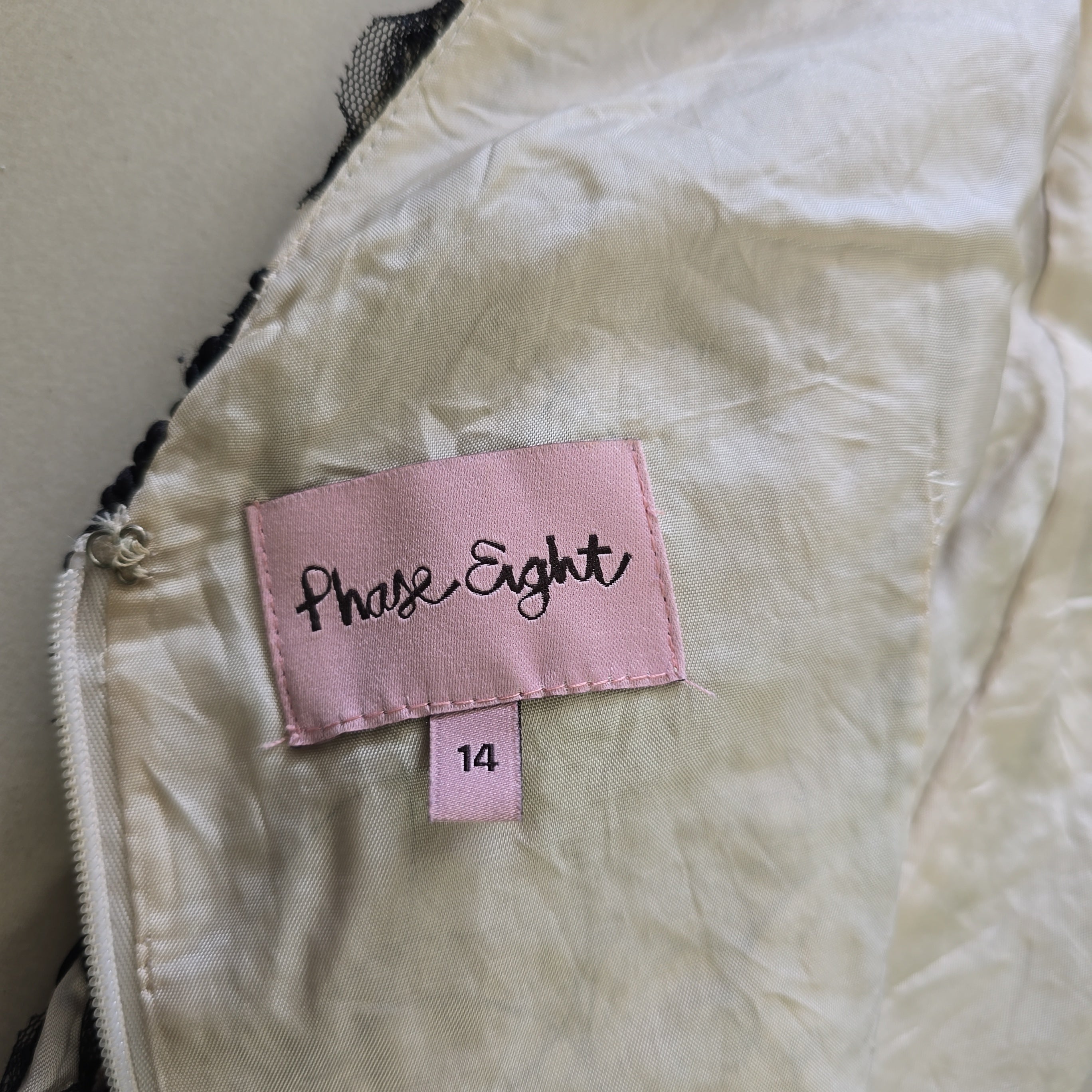 Close-up of a label on a garment with 'Phase Eight' branding.