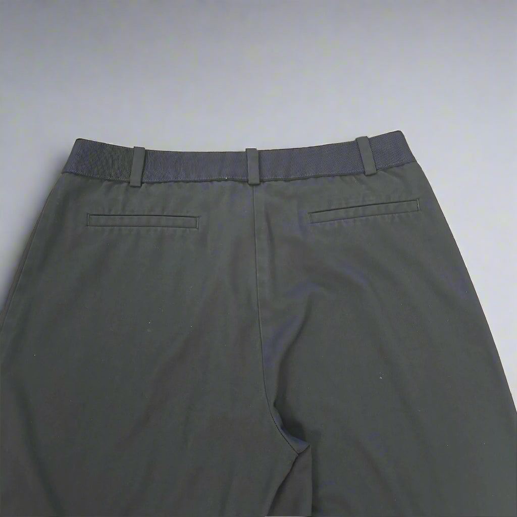 Dark blue pants on a tiled floor