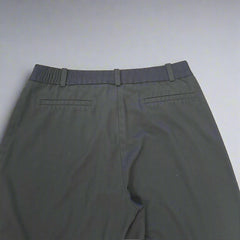 Dark blue pants on a tiled floor