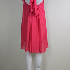 Pink dress on a mannequin against a plain background