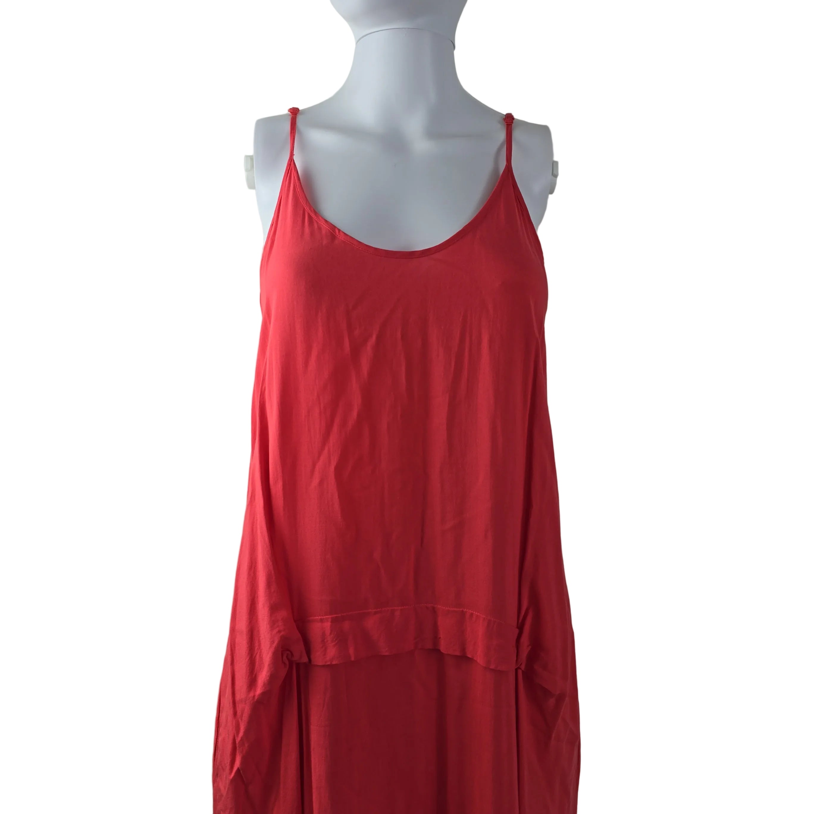 Red dress on a mannequin against a plain background