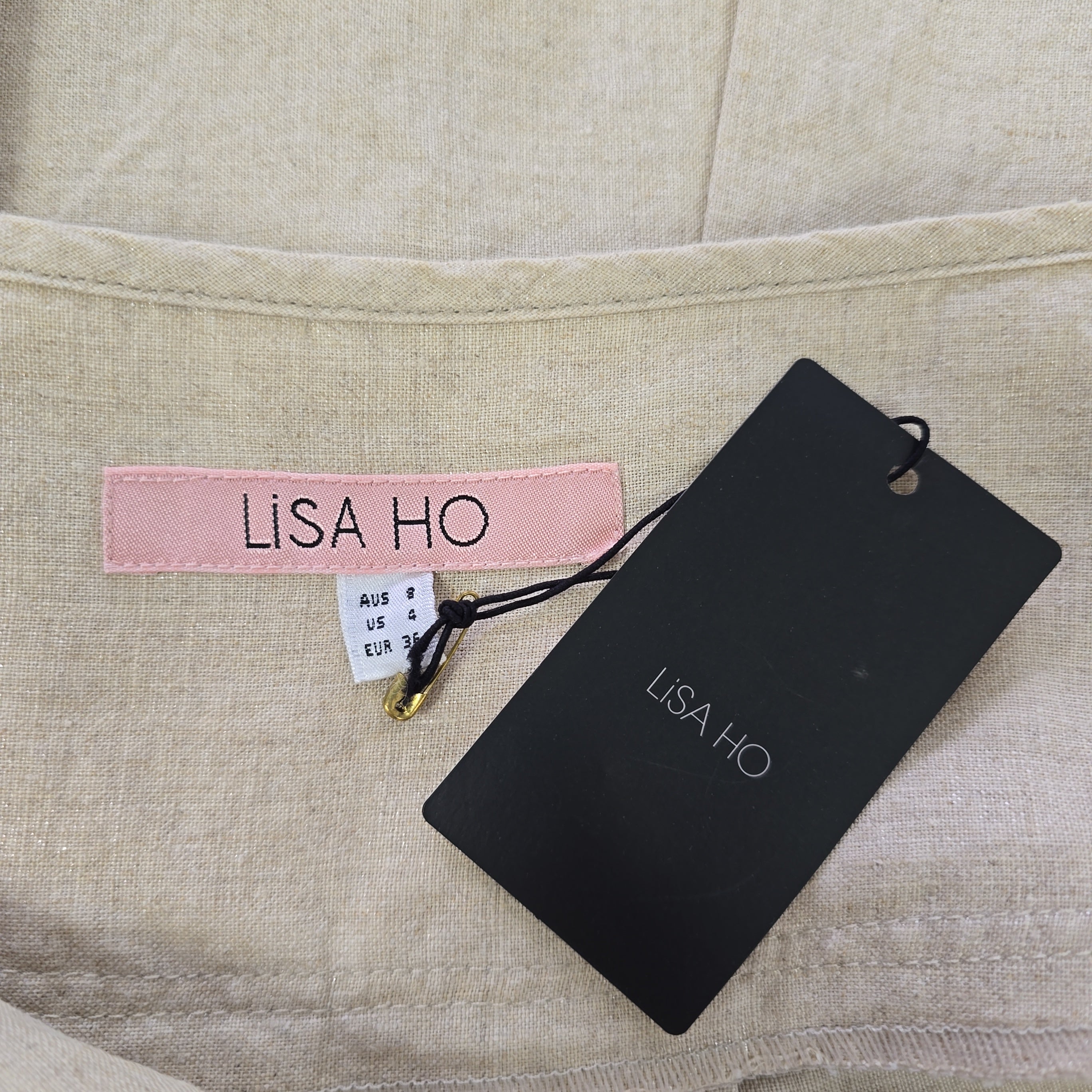 LISA HO label on a beige fabric background