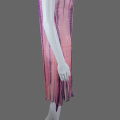 Mannequin arm with a pink and purple patterned fabric on a white surface.
