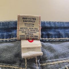 Close-up of a denim fabric with a label on a beige background