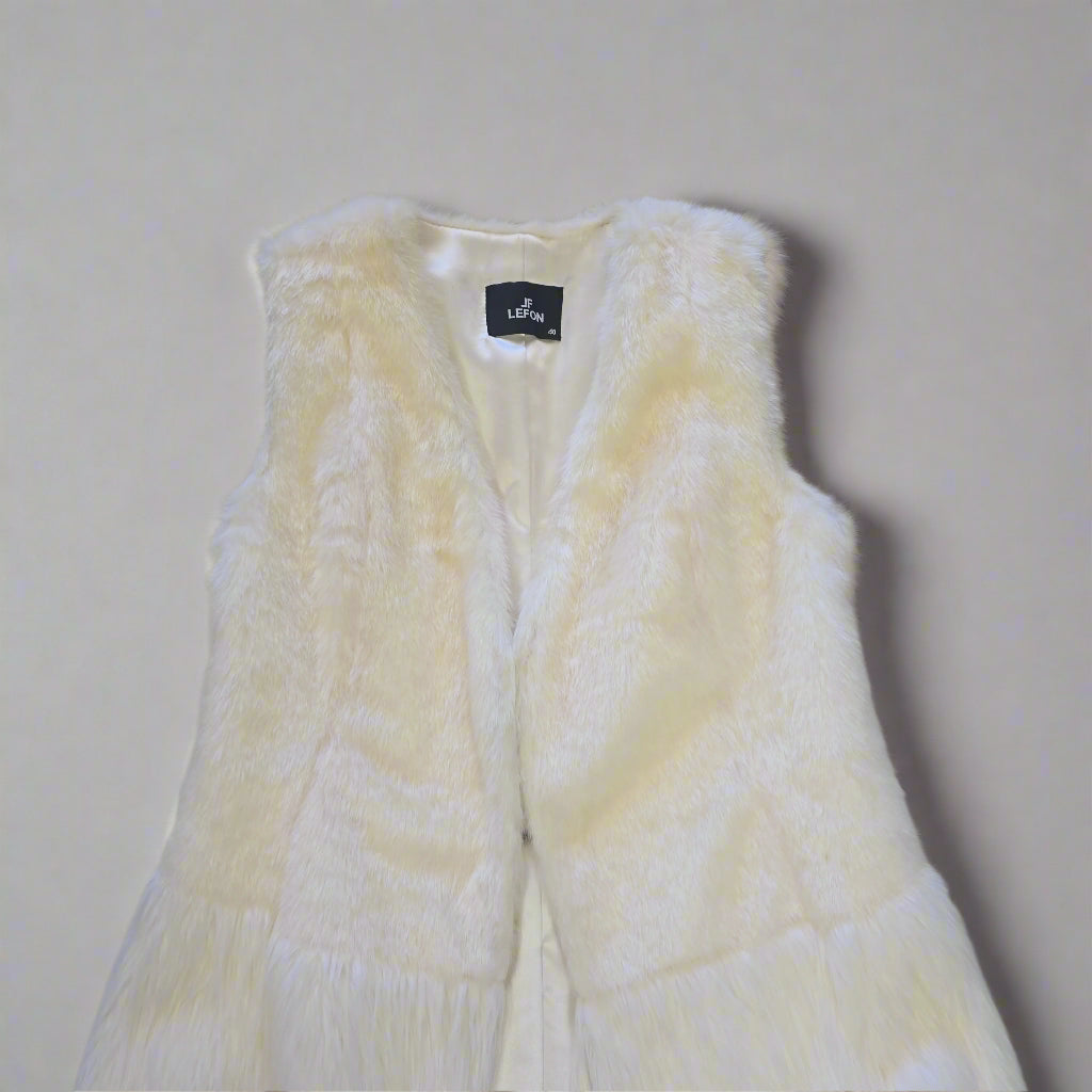 White textured garment with a brand label on a tiled floor