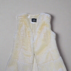 White textured garment with a brand label on a tiled floor