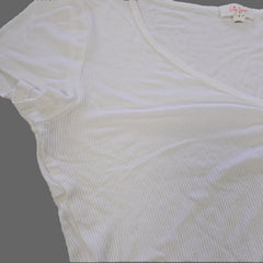 White ribbed tank top on a light gray surface