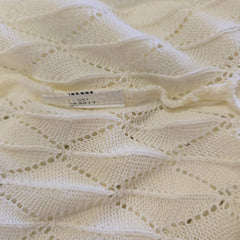 Close-up of a textured white fabric with a label.
