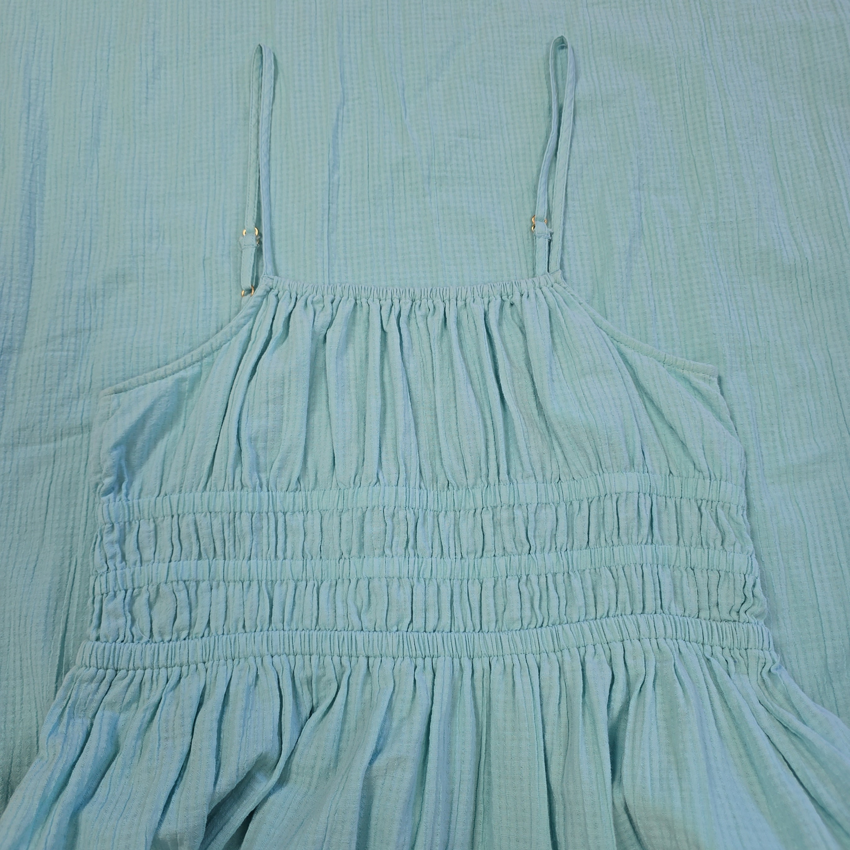 Close-up of a light blue fabric with pleated details